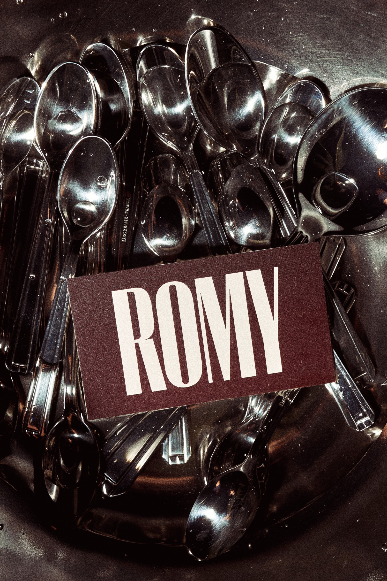 Burgundy ROMY matchbook on silver spoons
